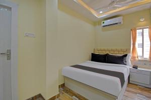 a bedroom with a bed and a window and avertisement at Collection O Ketan Regency Near Acropolis Mall in Kolkata