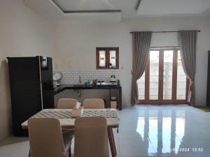 a kitchen and dining room with a table and chairs at Zavira House Purwokerto in Purwokerto