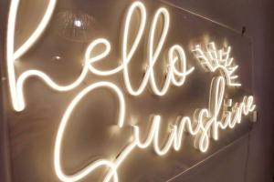 a neon sign that says rave interpretation on a wall at Boho Beach Vibes 2br Apt 2 in Makati in Manila