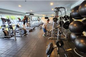 a group of people in a gym with weights at Boho Beach Vibes 2br Apt 2 in Makati in Manila
