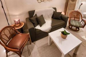 a living room with a couch and a table at Boho Beach Vibes 2br Apt 2 in Makati in Manila