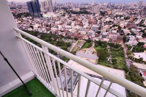 a balcony with a view of a city at Boho Beach Vibes 2br Apt 2 in Makati in Manila