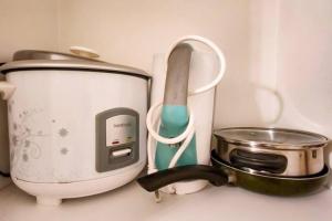 a counter top with a toaster and a toasteruclear at Boho Beach Vibes 2br Apt 2 in Makati in Manila
