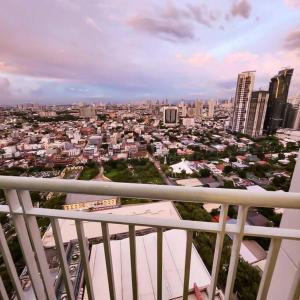 a view of a city from the balcony of a building at Boho Beach Vibes 2br Apt 2 in Makati in Manila
