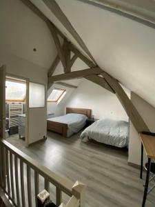 Ένα ή περισσότερα κρεβάτια σε δωμάτιο στο Petite maison de ville