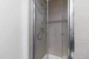 eine Dusche mit einer Glastür in einem Badezimmer in der Unterkunft SMART Studio with Ultra Fast 1Gbps WiFi and Air Conditioning in Prag