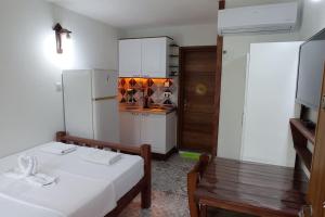 a room with a kitchen with a bed and a table at Finike Apart Orion in Finike