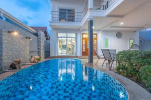 a swimming pool in the middle of a house at Sunflower Pool Villa Central Pattya in Pattaya South