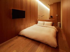 Postel nebo postele na pokoji v ubytování MUJI HOTEL GINZA