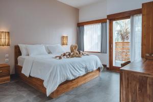 a bedroom with a bed with a teddy bear on it at Blue Marlin Dive Gili Air in Gili Islands +53 photos