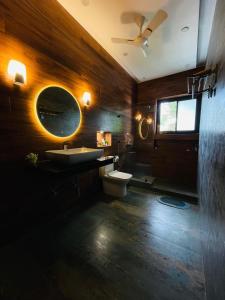 a bathroom with a sink and a toilet and a mirror at Nawabi SunRise HomeStay in Lucknow +23 photos