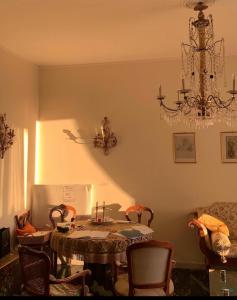 a dining room with a table and chairs and a chandelier at Genoa view & hiking in italian riviera in Genoa