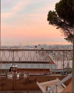 a table and chairs on a balcony with a view of the water at Genoa view & hiking in italian riviera in Genoa +31 photos