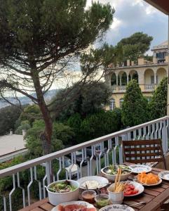 a table with plates of food on a balcony at Genoa view & hiking in italian riviera in Genoa