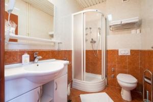 un bagno con lavandino, doccia e WC di Hotel N a Belgrado