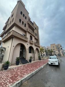 un bâtiment avec une voiture garée devant dans l'établissement Galaxy Hotel & Apartments, à Rawalpindi 55 autres photos