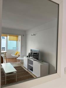 a reflection of a living room with a mirror at Apartament sea view and direct beach access in Platja de l'Arenal +15 photos