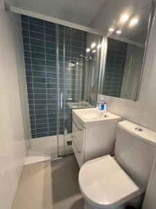a bathroom with a toilet and a sink and a shower at Apartament sea view and direct beach access in Platja de l'Arenal