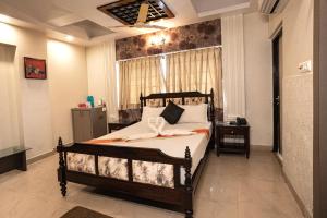 a bedroom with a bed and a window at The Piku's in Digha +32 photos