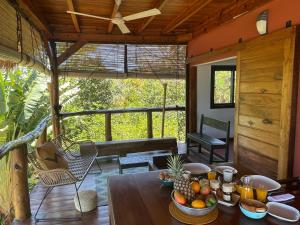 a room with a wooden table with fruit on it at lodges cap dore in Andilana