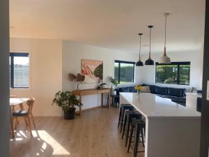 a kitchen and living room with a couch and a table at Brooklyn Views in Feilding