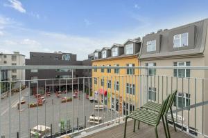 a balcony with a green chair on a building at Luxury penthous - 3 BR - 2 Bath - FreeParking - Downtown in Reykjavík +25 photos