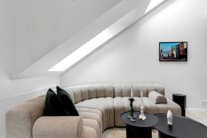 a living room with a couch and a table at Luxury penthous - 3 BR - 2 Bath - FreeParking - Downtown in Reykjavík