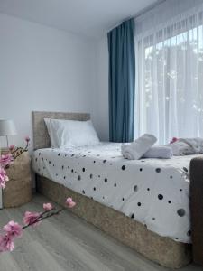 a bedroom with a bed with polka dot sheets and a window at Guest house Villa Orlovo in Orlovo +33 photos