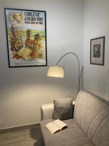 a living room with a couch and a movie poster at La Corte in Alba