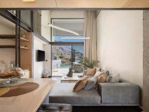 a living room with a couch and a table at Nature's Den in Frangokastello