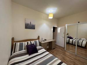 a bedroom with two beds and a mirror at Charming 2-Bedrooms City Centre Apartment-No Party in Aberdeen +17 photos