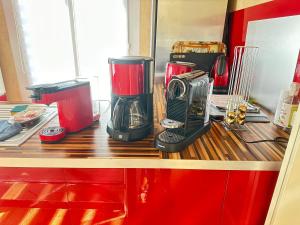 a kitchen counter with a coffee maker and a blender at La Petite Maison de Jane in Reims +2 photos