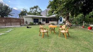 a group of chairs around a table in a yard at The Pecan Resort in Gilgit