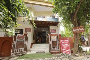 a house with signs in front of a building at Basil Inn Home Stay Walking Distance From Taj Mahal Agra in Agra