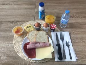 a plate of food with meat and cheese and eggs at La Saou in Fonsorbes
