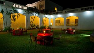 an outdoor patio with tables and chairs at night at Nala Hotels in Nāmakkal