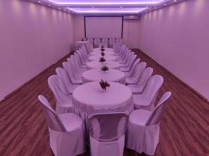 a row of tables and chairs in a room at XCELSIOR HOTEL & SPA in Shillong