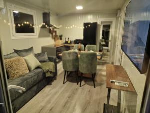 a living room with a couch and a table at Emerald Chalet Bran in Bran