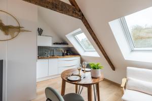 a kitchen and dining room with a table and chairs at Studio Charmant -Cœur de Lannion - Tout equipé in Lannion +18 photos