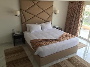 Voodi või voodid majutusasutuse Royal Maadi Hotel toas