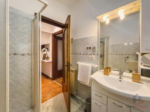 a bathroom with a sink and a shower with a mirror at Bike Refuge - WiFi - Free Ticket Museum - Smart TV in Altare +26 photos