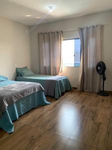 Ένα ή περισσότερα κρεβάτια σε δωμάτιο στο Área de lazer Recanto Feliz