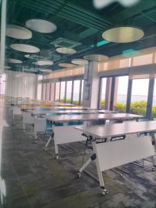 a row of tables in a room with windows at Riveria City at KL Sentral by KKT in Kuala Lumpur +47 photos