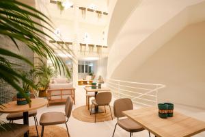 a room with tables and chairs in a building at Hotel Atlante Sanxenxo Boutique in Sanxenxo