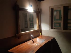 a bathroom with a wooden sink and a mirror at Agro Village Resort , Kalpitiya in Kalpitiya +163 photos