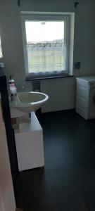a bathroom with a sink and a window at Elaine in Schongau +5 photos