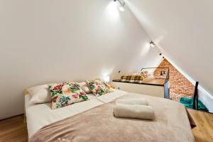 a bedroom with a bed in a attic at Tatra Wooden Apartment in Ratułów