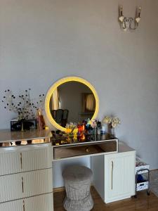 a bathroom with a vanity with a yellow mirror at Baku Private Villa in Baku