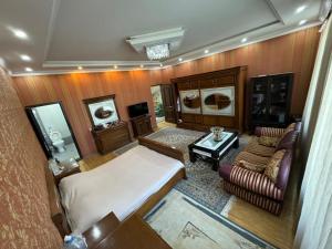 an overhead view of a bedroom with a bed and a couch at Baku Private Villa in Baku