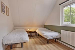 Postel nebo postele na pokoji v ubytování Heemhoeve Lodge
